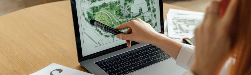 pexels-photo-5243989-5243989 Architect reviewing landscape design on laptop, enhancing architectural projects from home office.